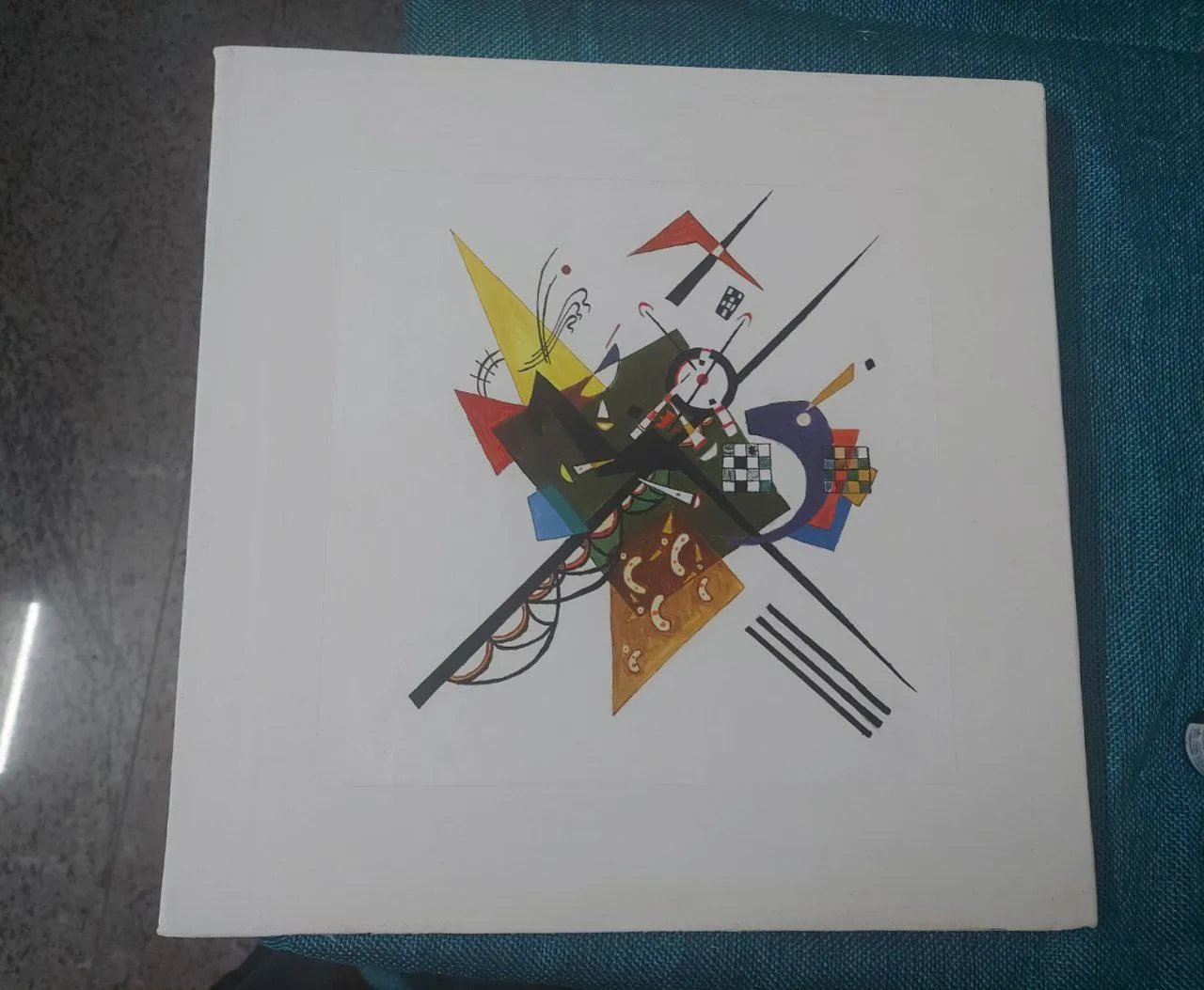 A square canvas with crossing black lines and coloured geometric shapes on white.
