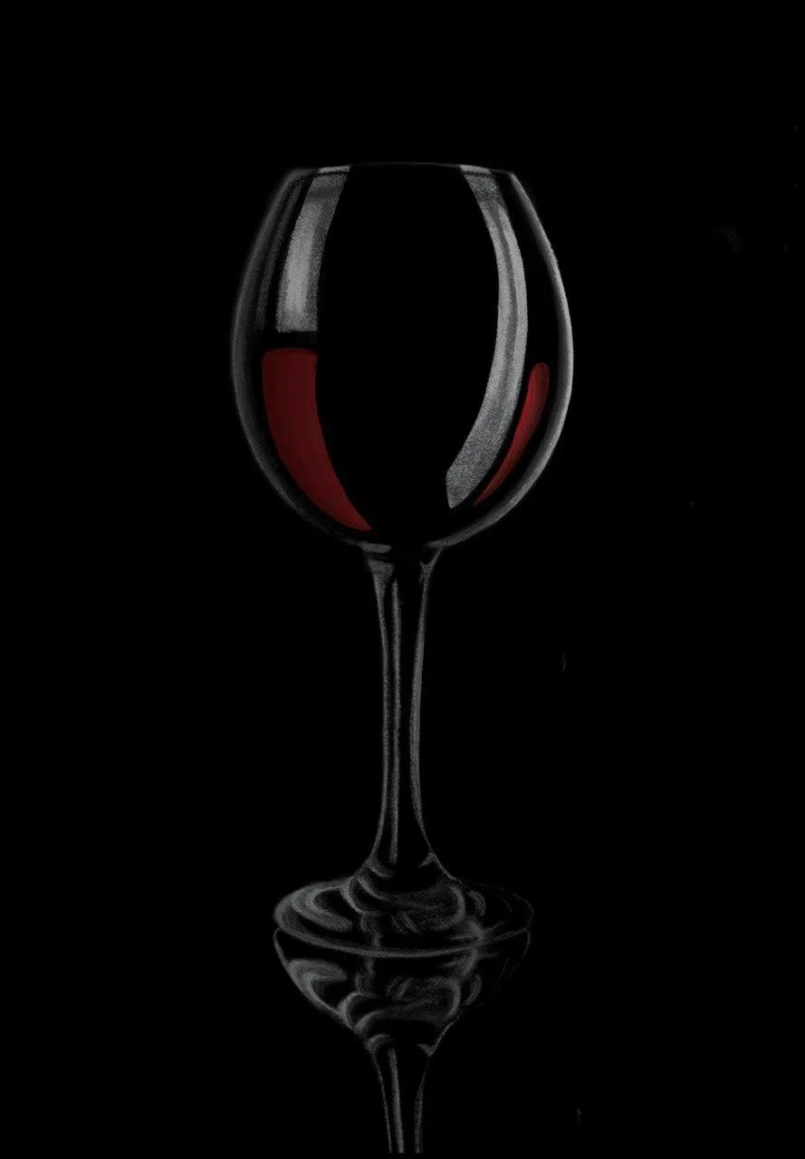 A glass of red wine on a black background.